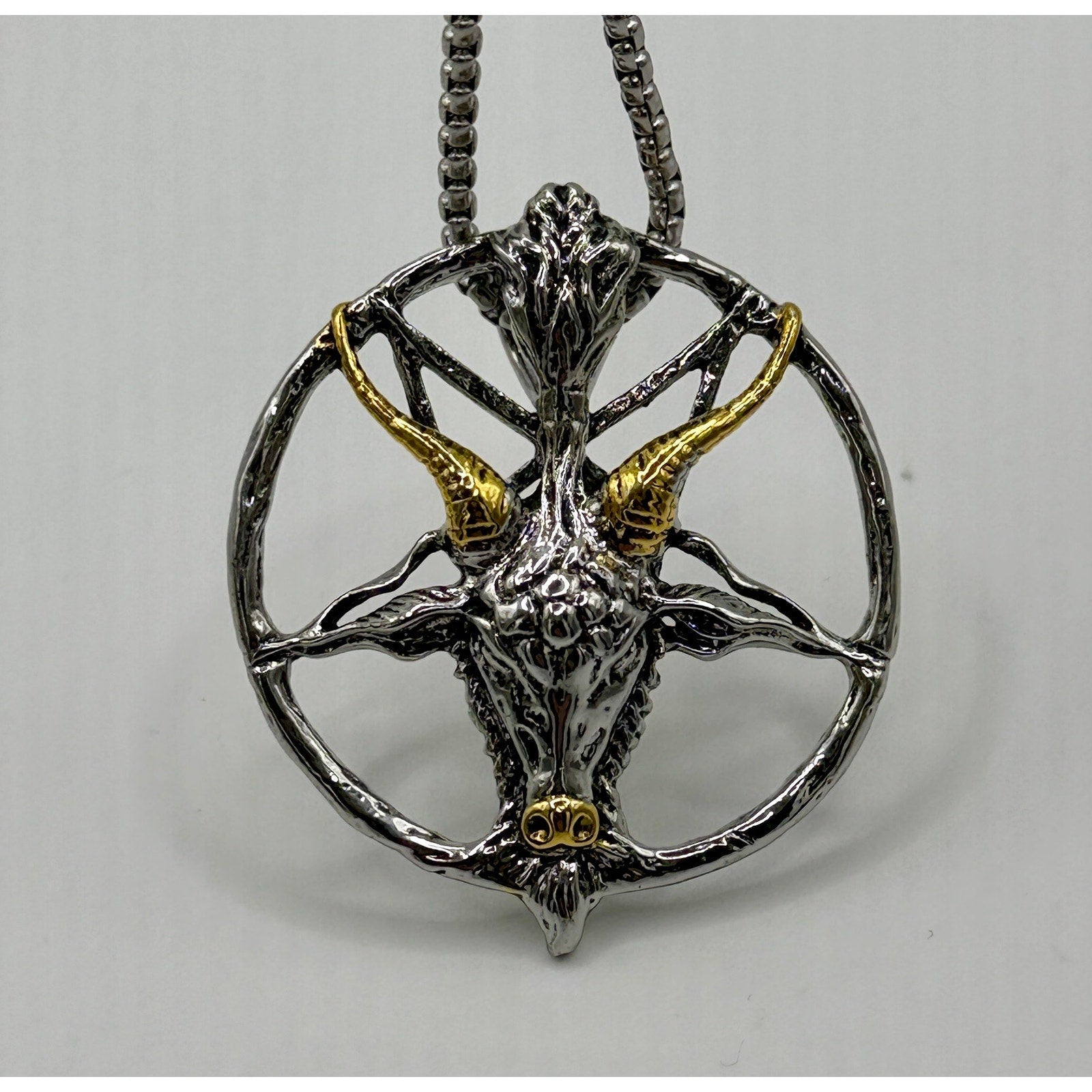 TornSlayer Goat Head Pentagram Necklace in silver and gold on a 22" chain.
