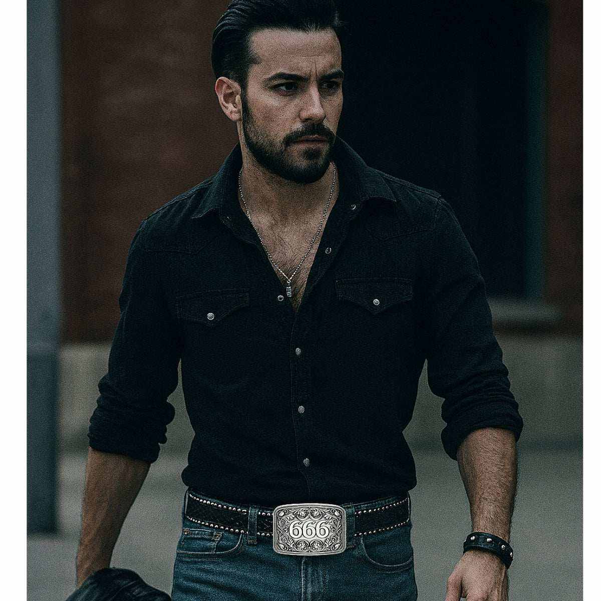 Man wearing studded gothic belt with 666 buckle and black shirt